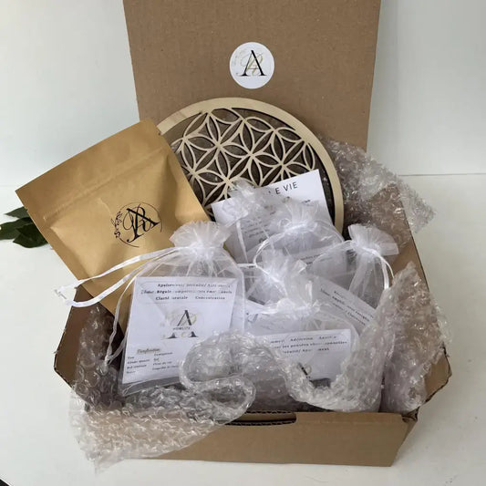 Kit Découverte Lithothérapie Aura de Roche boîte ouverte avec pierres en sachets organza et fleur de vie