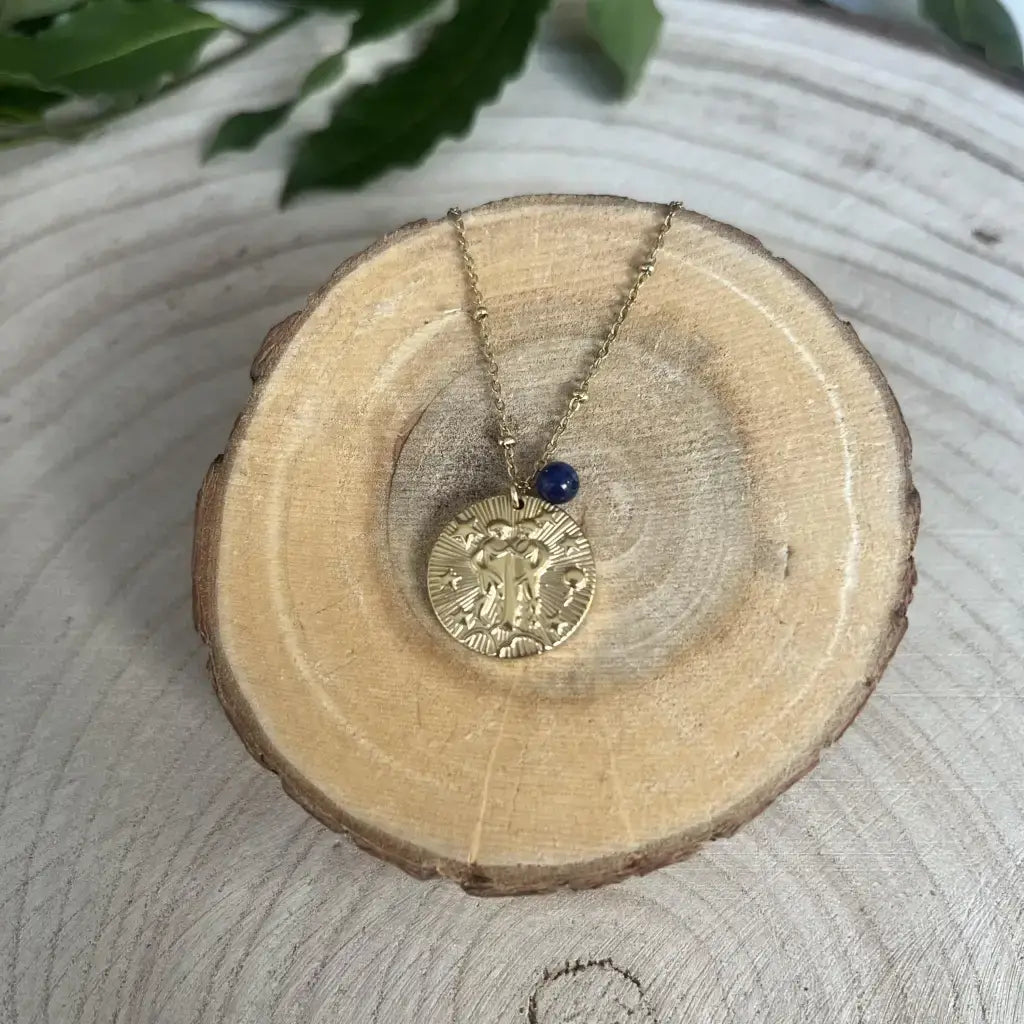 Pendentif Gémeaux avec Pierre de Pouvoir en laiton et chaîne délicate sur un support en bois