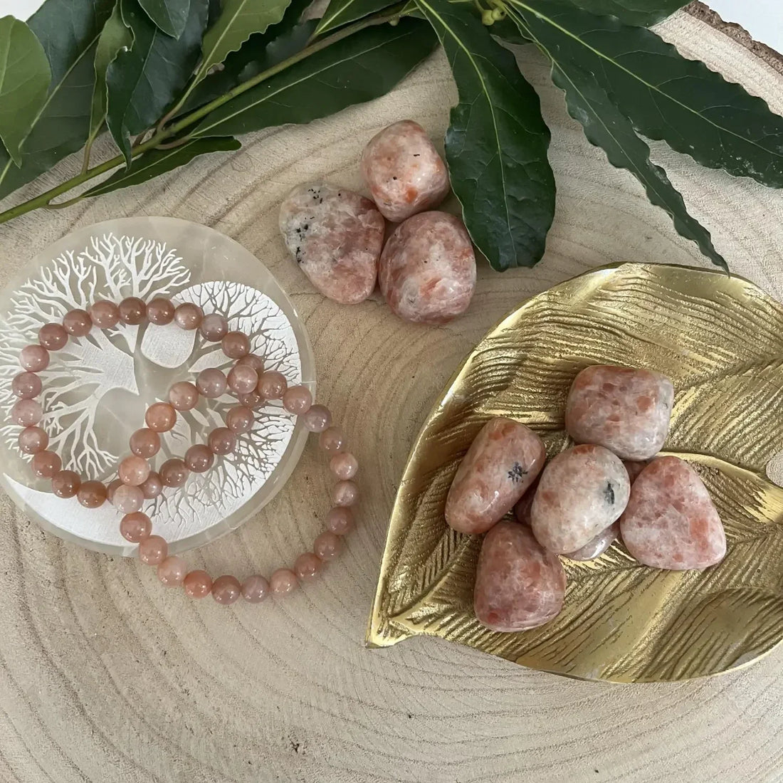 Bracelet et pierres de la Pierre de Soleil sur une assiette dorée, représentant la signification Pierre de Soleil