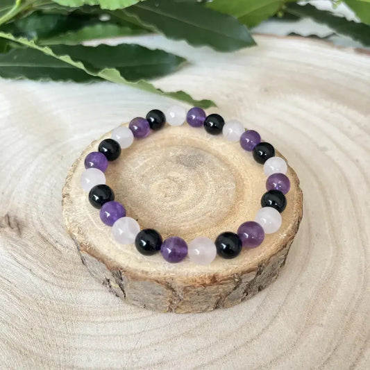 Bracelet Accompagnant du Deuil en pierres naturelles violettes et noires sur une base en bois